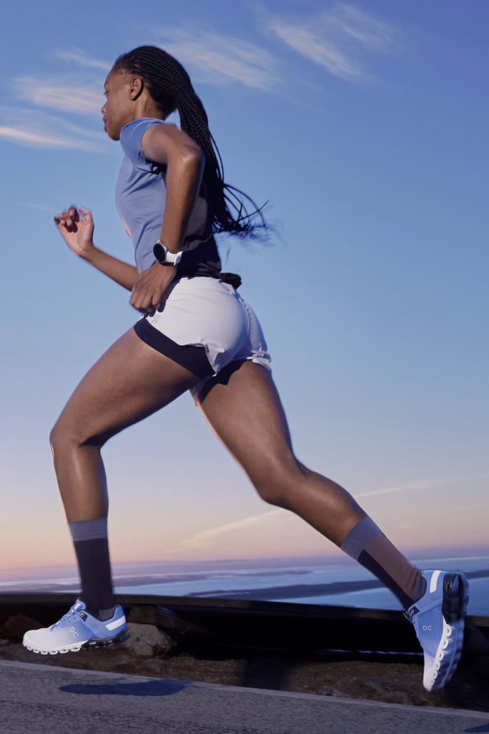 Woman running on a path with a scenic background