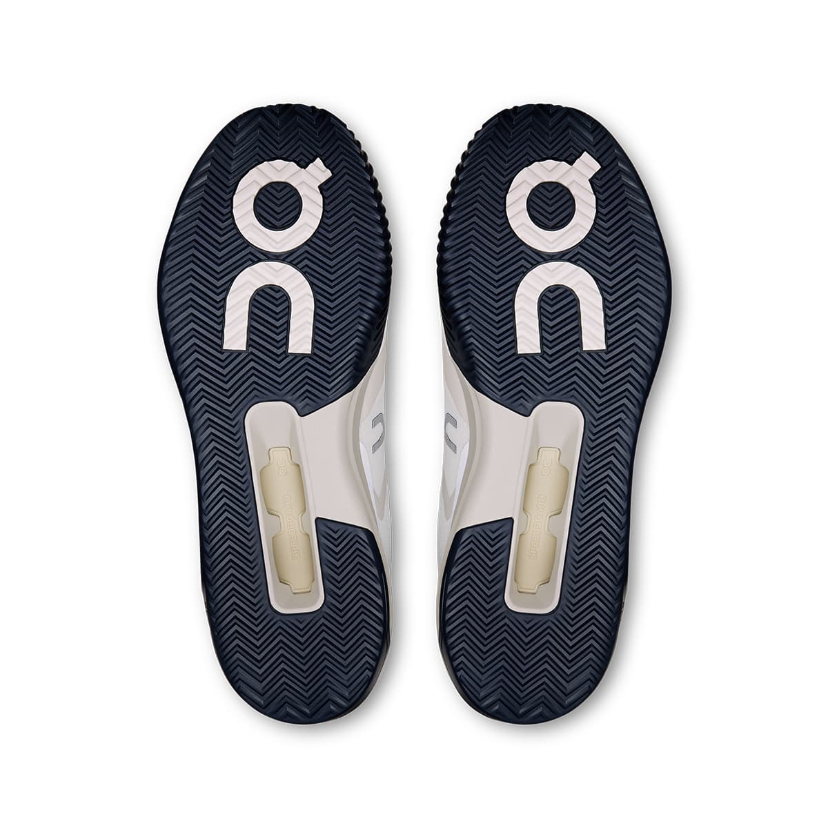Soles of the On The Roger Advantage Pro Clay White-Cream men’s running shoes