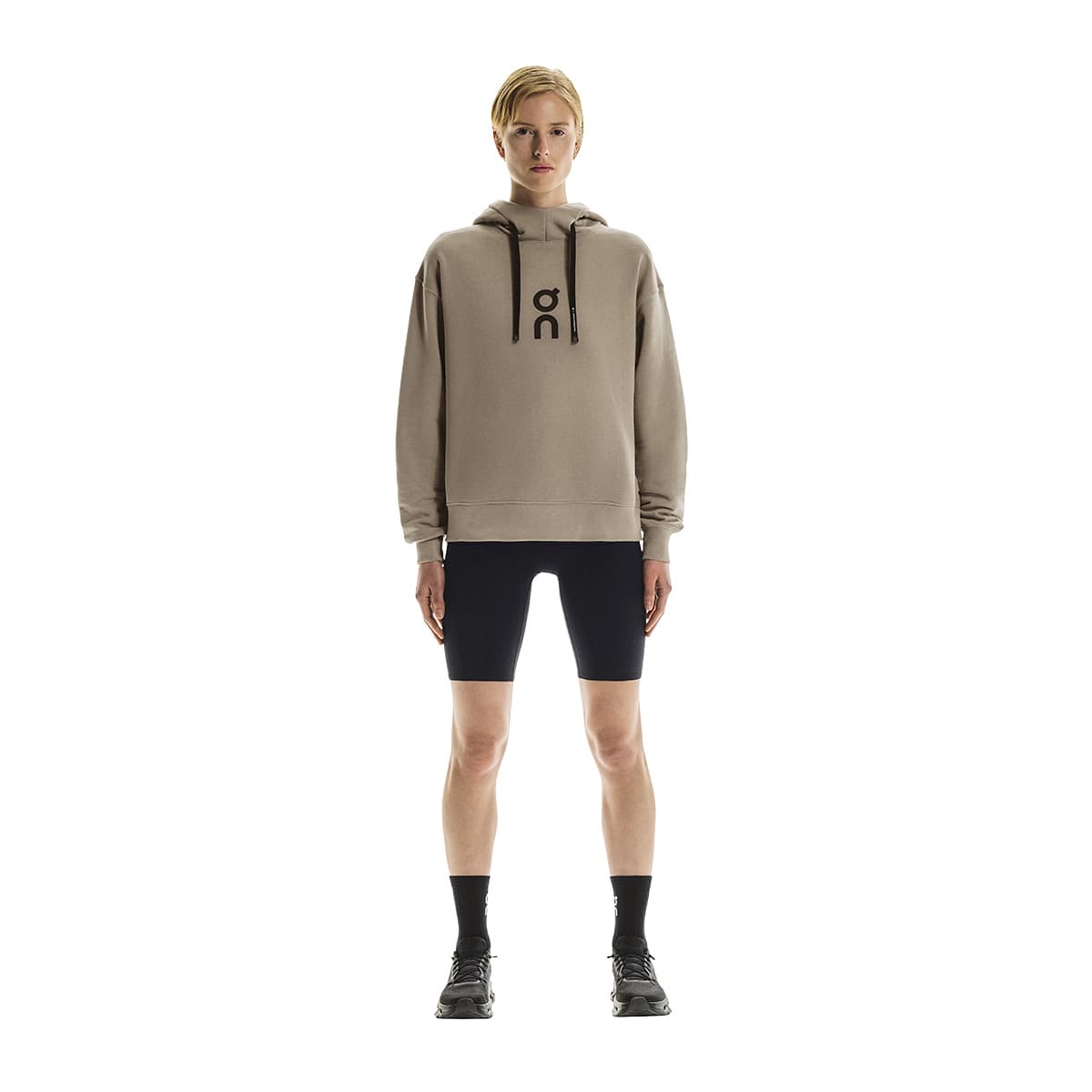 Full front view of female model wearing the On Club Hoodie in Desert