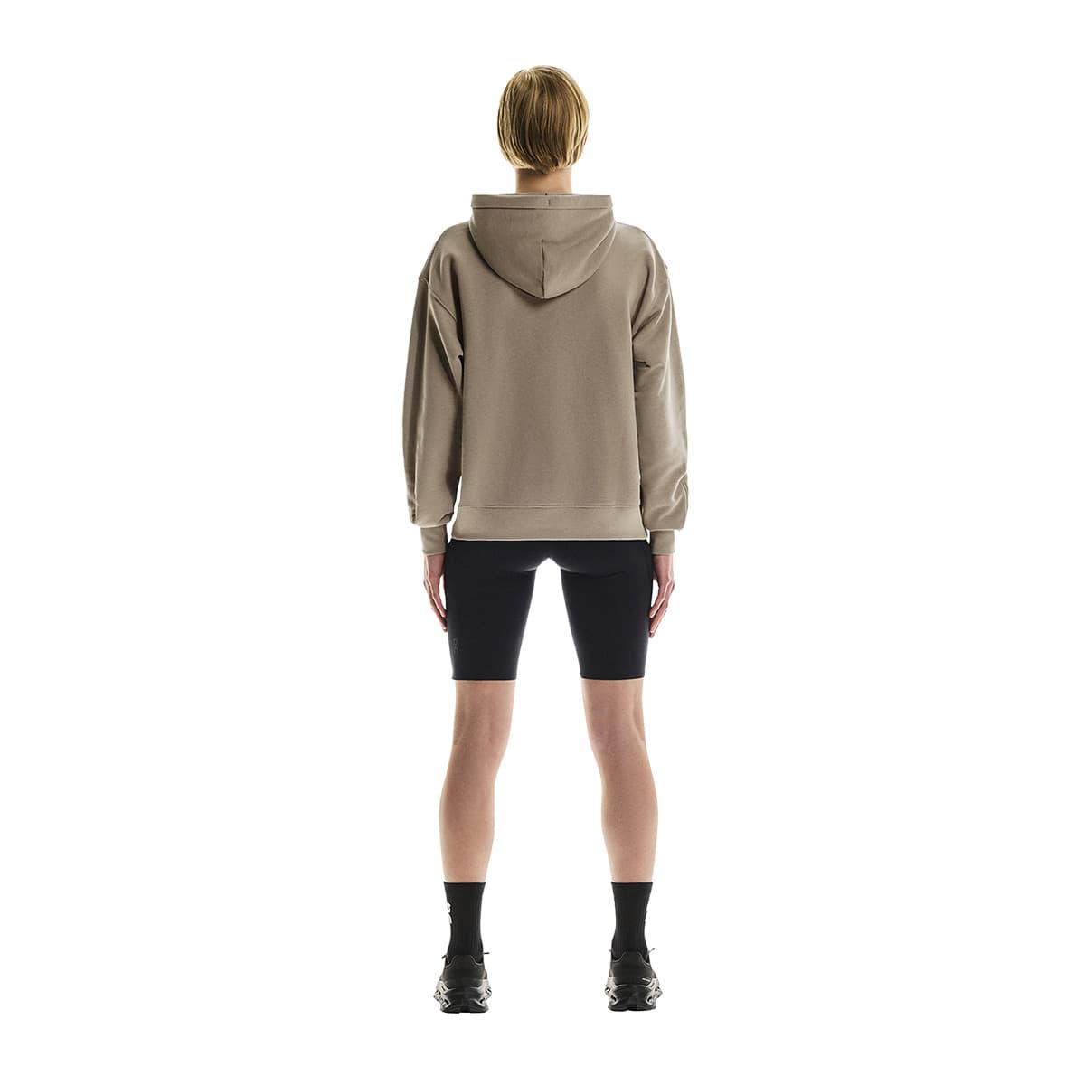 Full back view of female model wearing the On Club Hoodie in Desert