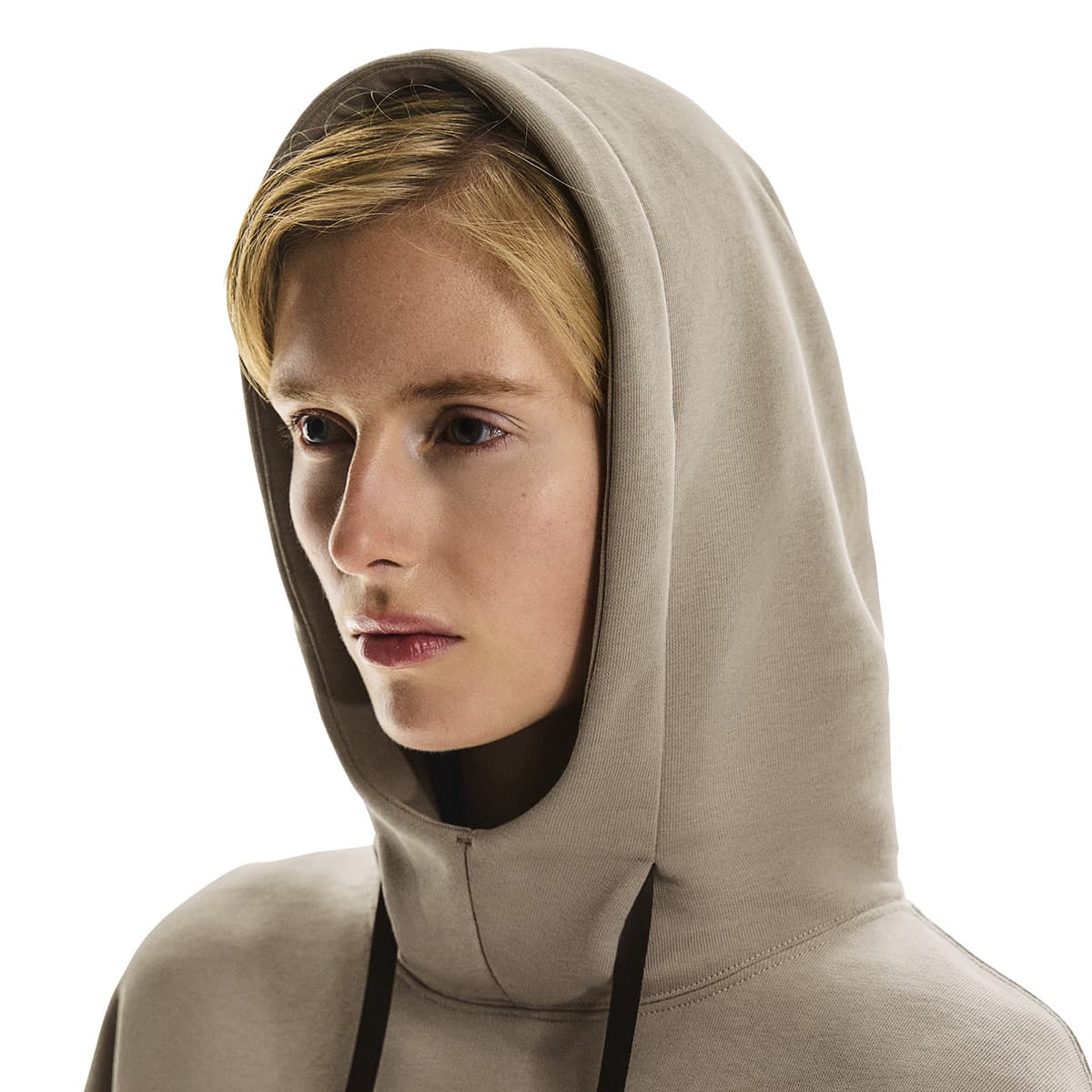 Close-up side profile of female model wearing the hood up on the On Club Hoodie in Desert