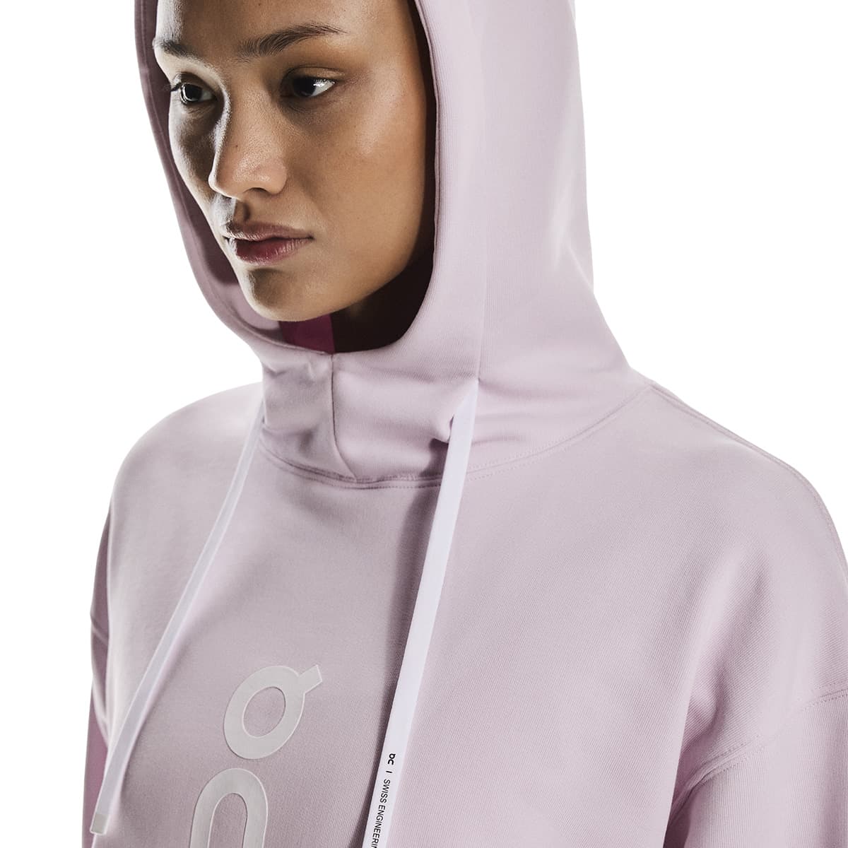 Close-up side profile of female model wearing the hood up on the On Club Hoodie in Orchid
