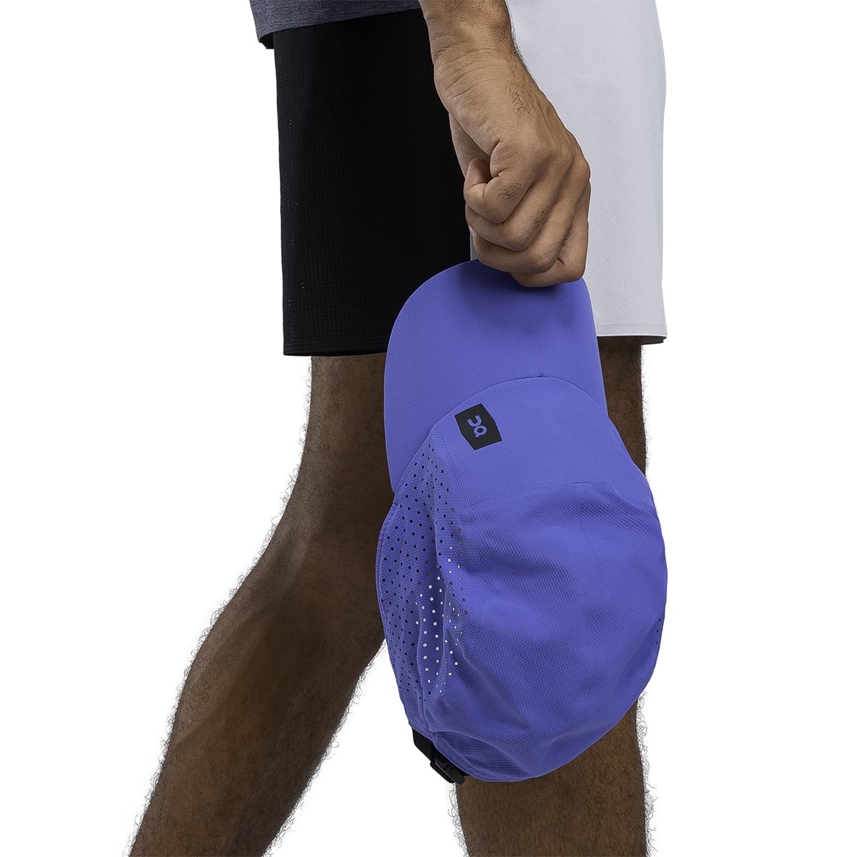 Male Model holding the On Lightweight Cap Colour Cobalt