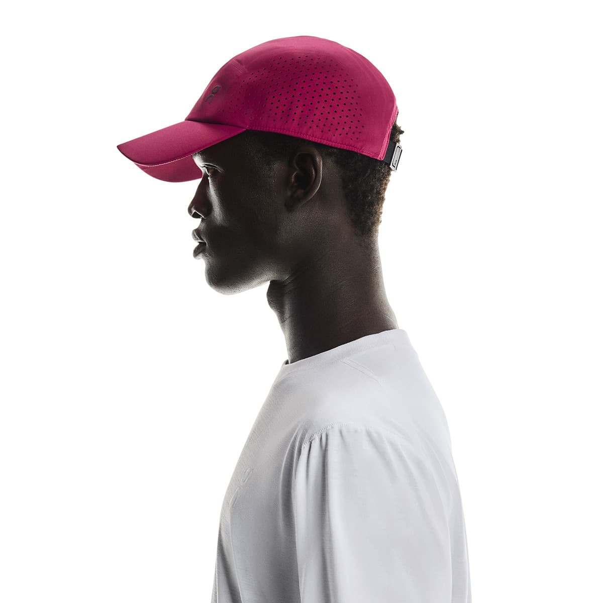 Side profile of male model wearing the On Lightweight Cap in Grenadine