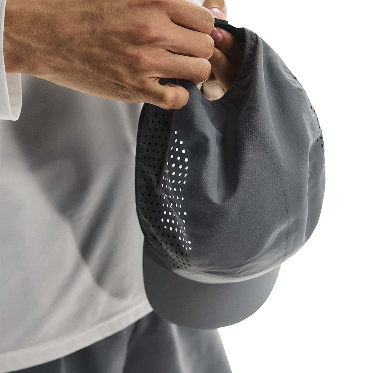 Close-up of interior detail and strap adjustment of the On Lightweight Cap in Rock