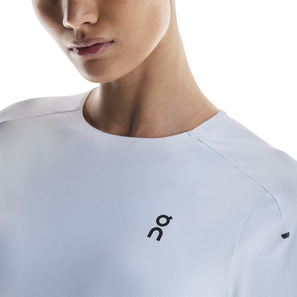 Woman wearing the On Performance T Colour Arctic-Eclipse - Front Detail Logo