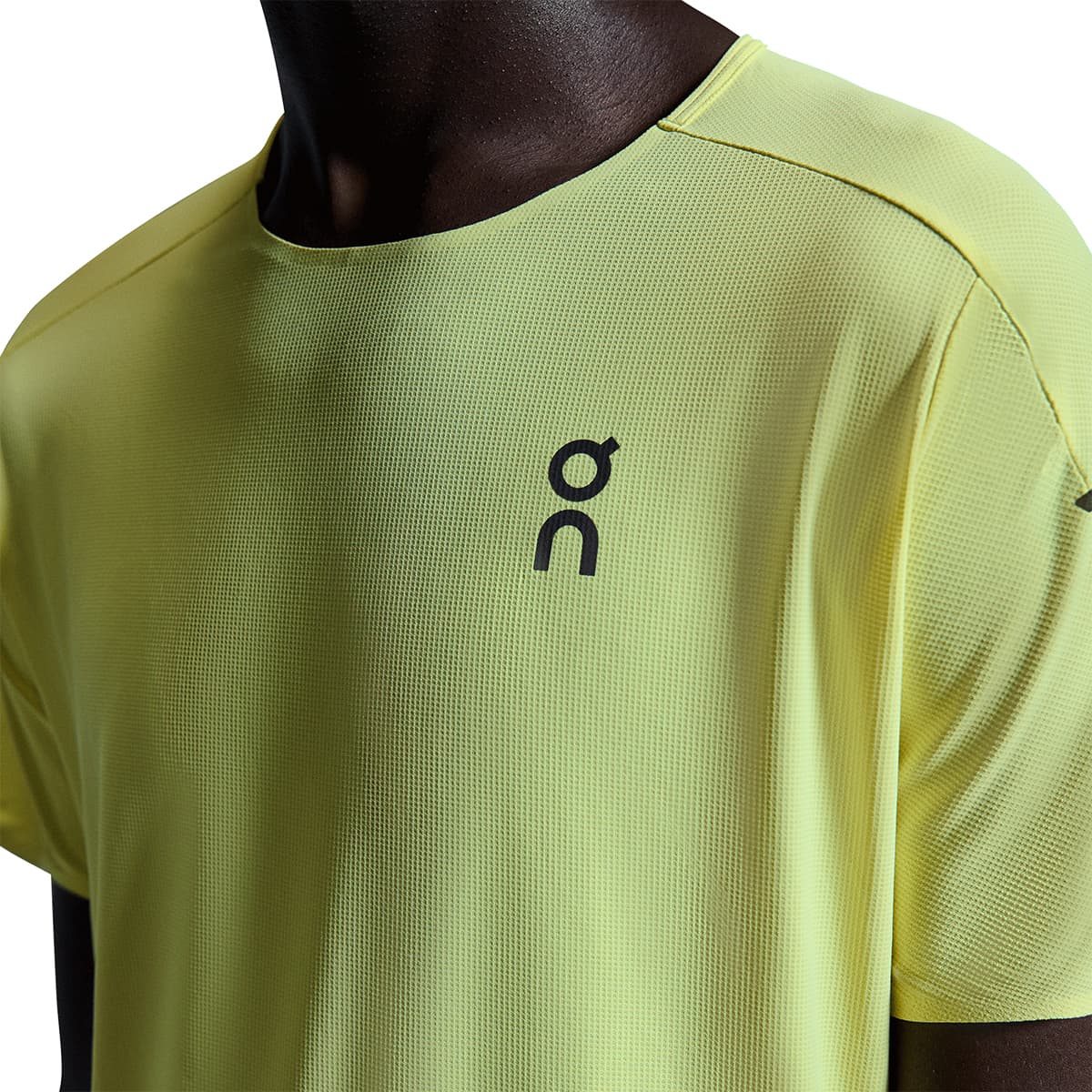 Man wearing the On Performance T Colour Limelight-Lime - Front View Close up logo and stitching