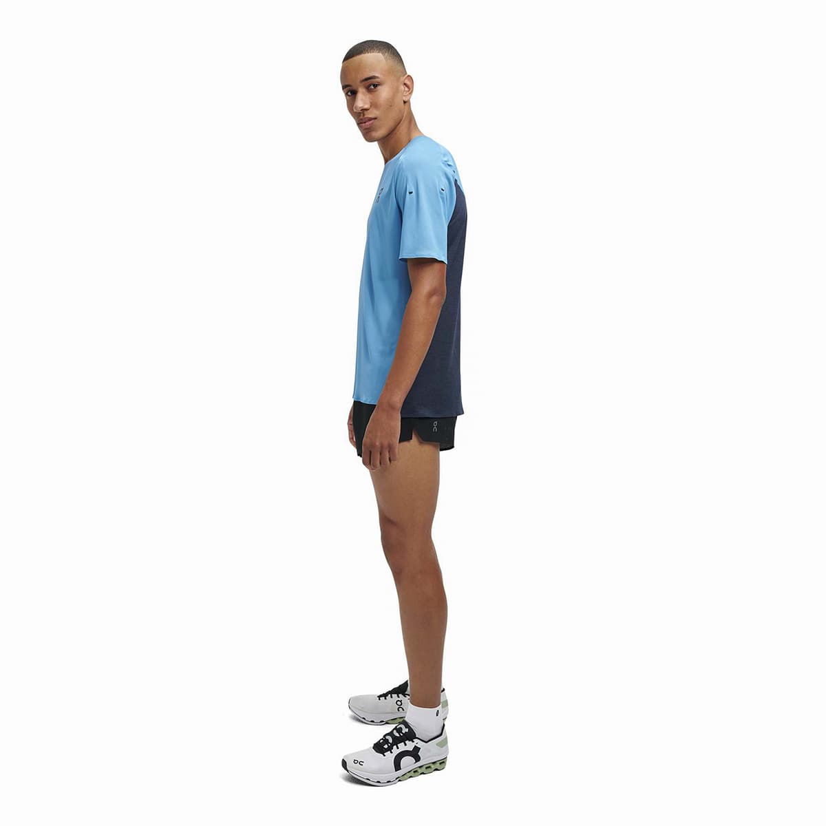 Man wearing the On Performance T Colour Niagra-Navy - Side Angle