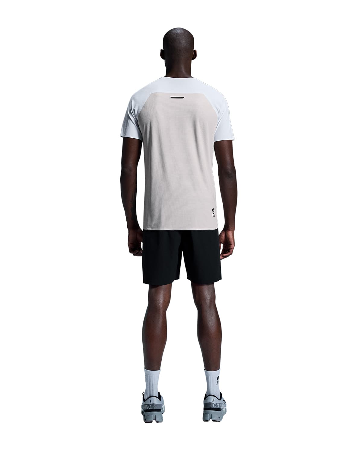 Man wearing the On Performance T Colour White Silver - Back View