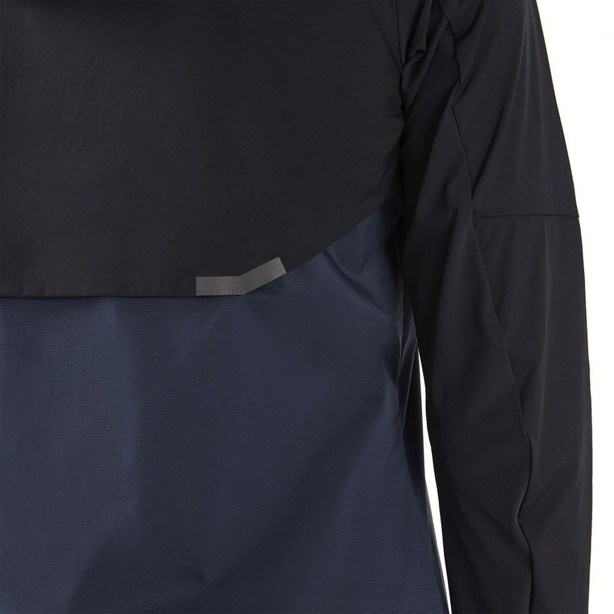 Woman wearing the On Weather Jacket Colour Black Navy - Back Reflective Detail