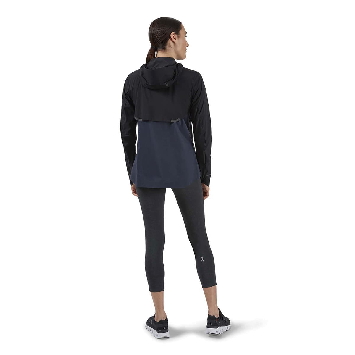 Woman wearing the On Weather Jacket Colour Black Navy - Back View