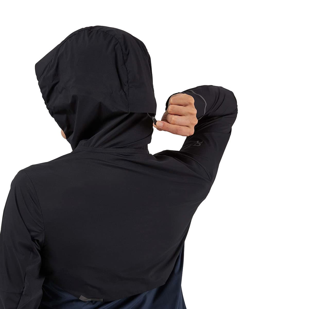 Woman wearing the On Weather Jacket Colour Black Navy - Back hoodie tag