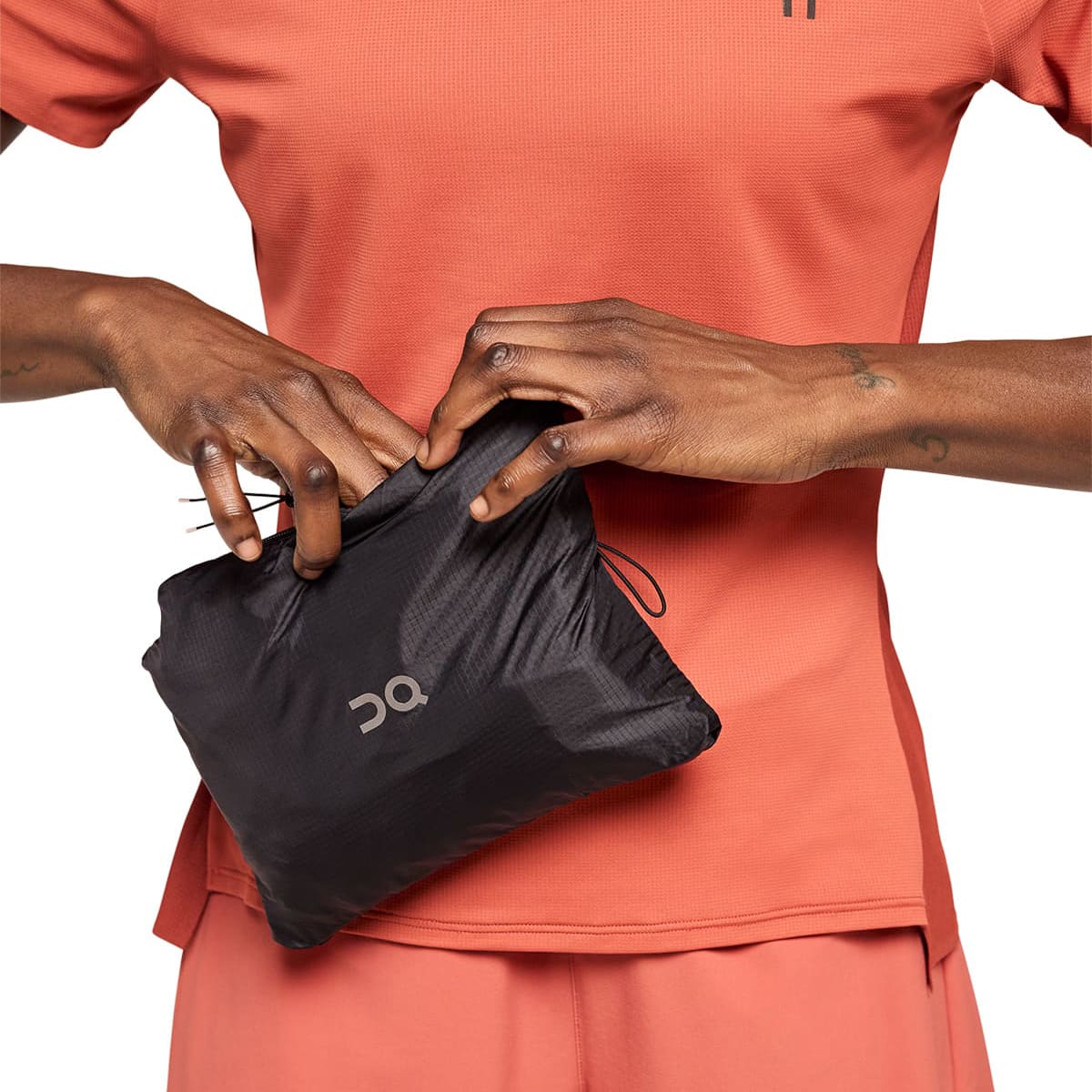 Woman wearing the On Weather Jacket Colour Black - Packing into Itself