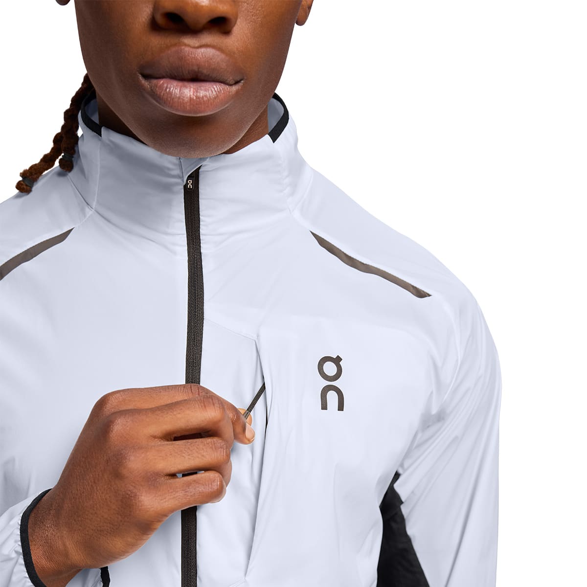 Man wearing the On Weather Jacket Colour White Black - Front Secure Pocket