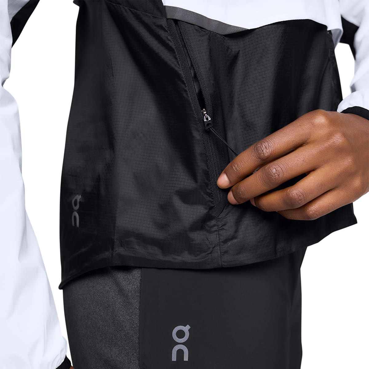 Woman wearing the On Weather Jacket Colour White Black - Detail Pocket Zip