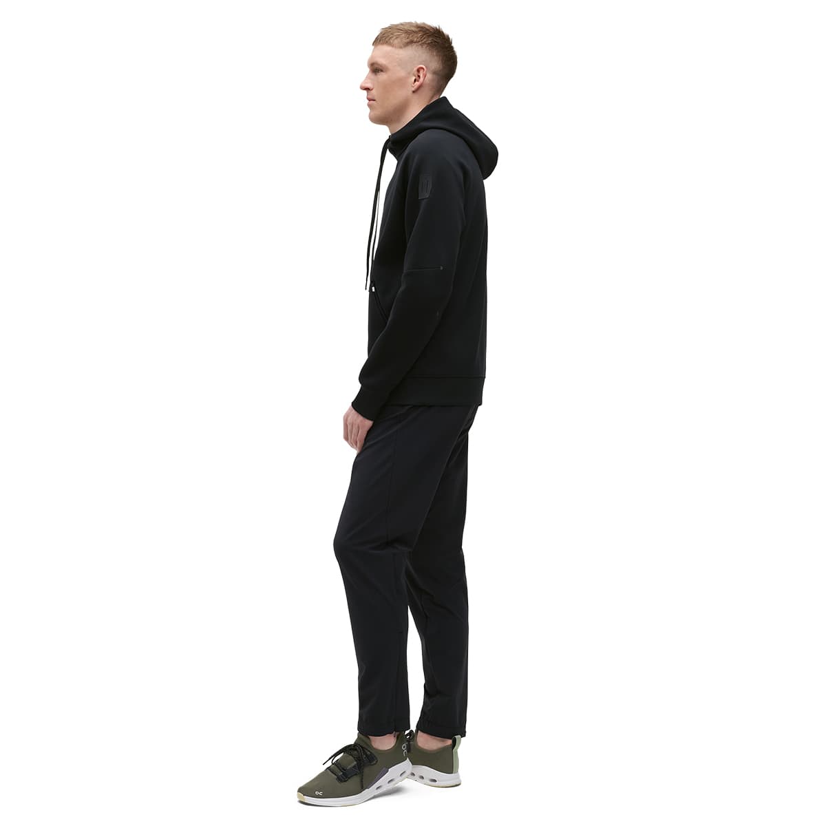 Man wearing the On Zipped Hoodie Colour black - Side Profile #color_black