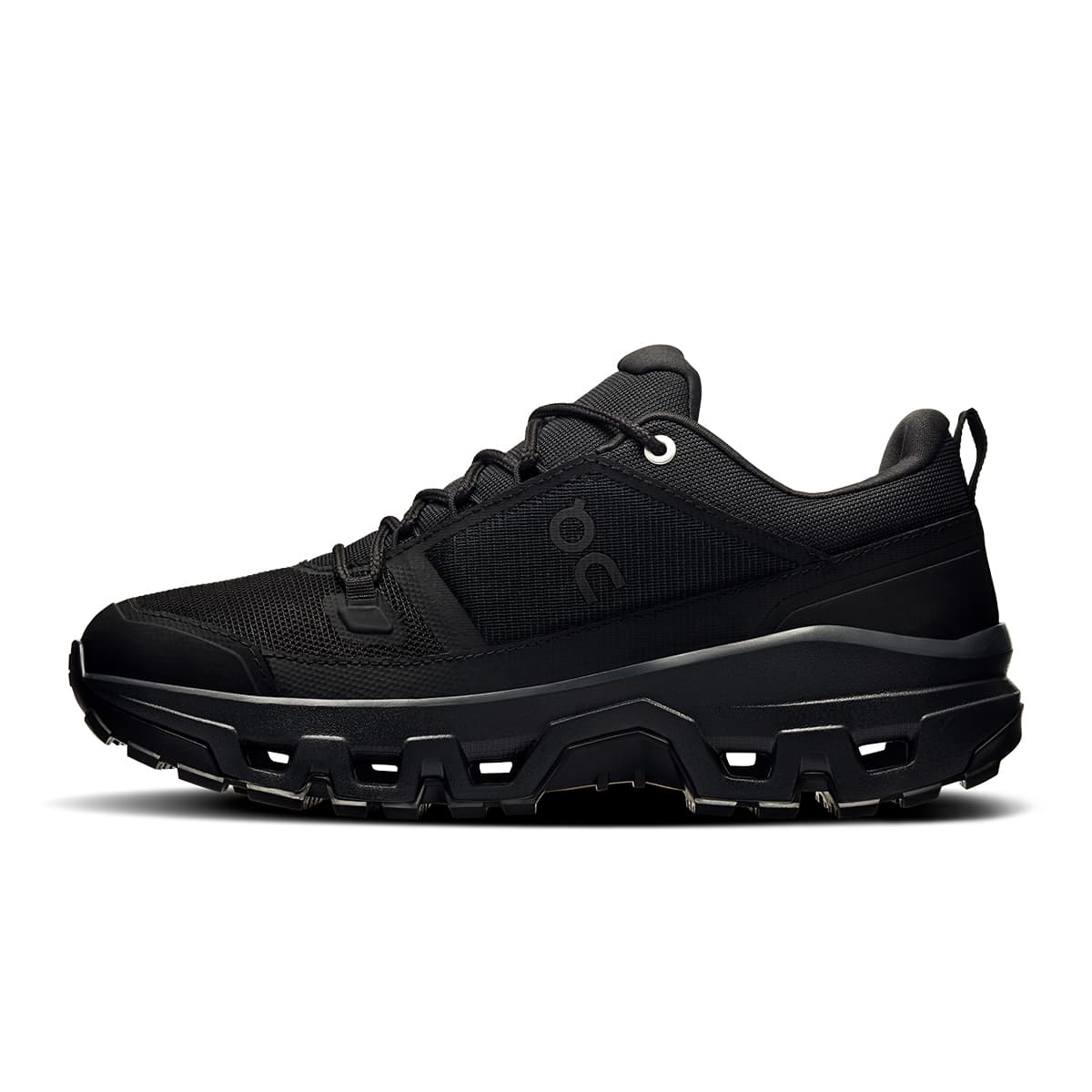Left side view of the On Cloudrock Low Black Black women’s running shoe #color_black-black