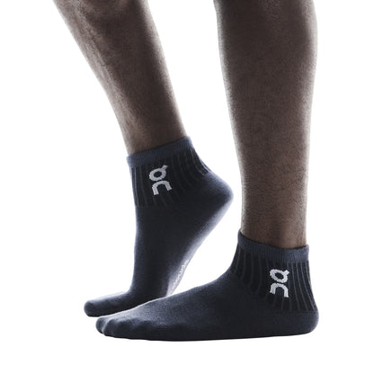Model wearing the On Logo Sock Mid 3P Colour Wash Navy - Side Angle 