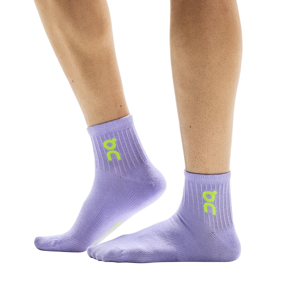Side view of model wearing the purple pair from the On Logo Sock Mid 3-Pack in Orchid Comet #color_orchid-comet