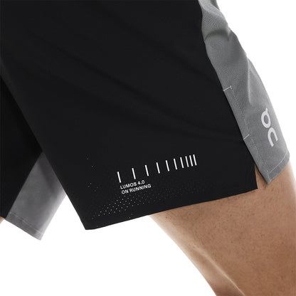 Detail of side hem on the On Performance Shorts Lumos in Black showing Lumos print and perforation 