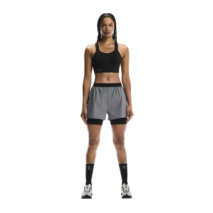 Full front view of female model wearing the On Performance Shorts Lumos in Black 