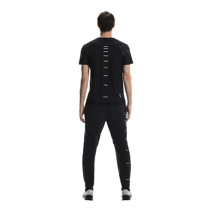 Rear view of male model wearing the On Apparel - Performance T Lumos Colour Black 