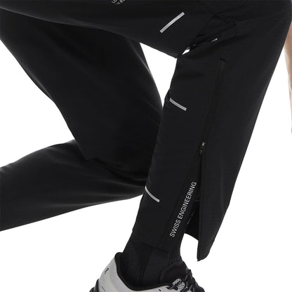 Side leg view of the On Weather Pants Lumos in Black showing ankle zips and “Swiss Engineering” print 