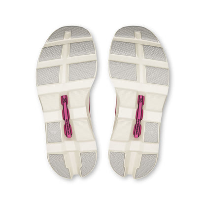 Soles of the On Cloudmonster Ivory-Grenadine women’s running shoes 