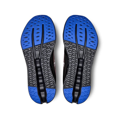 Soles of the On Cloudsurfer Black-Cobalt women’s running shoes 