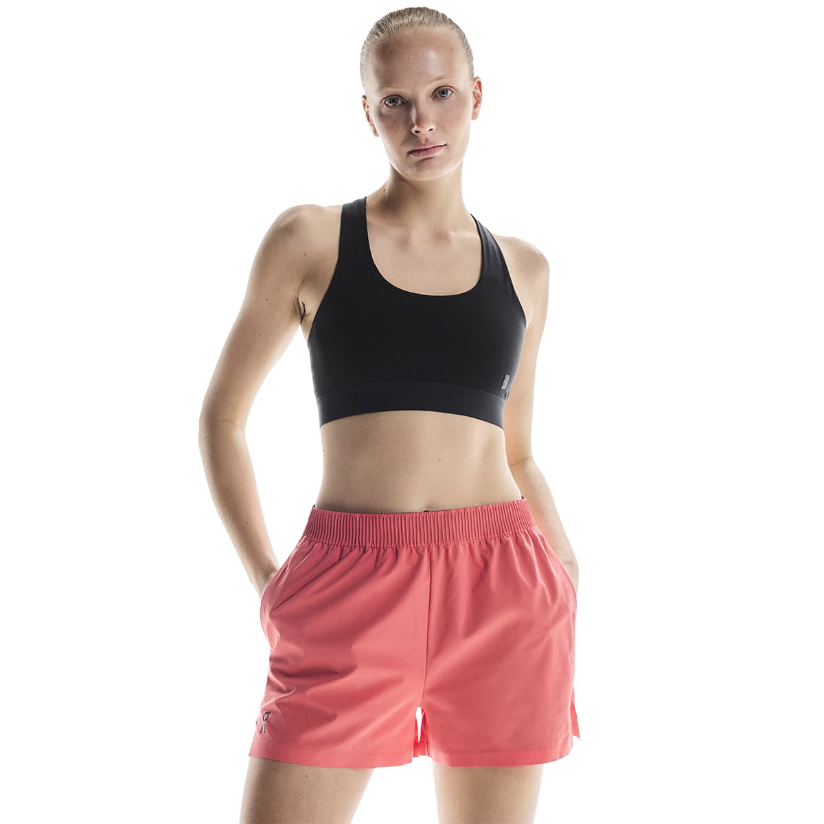 Woman wearing the On Focus Shorts Colour Coral - Front View Close Up #color_coral