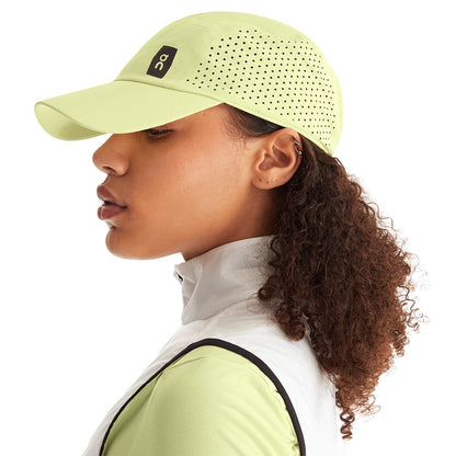 Female Model wearing the On Lightweight Cap Colour Hay 
