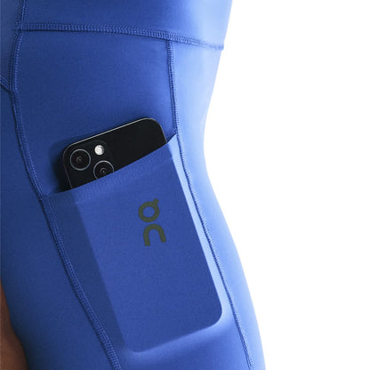 Close-up of side pocket on the On Performance Short Tights in Zaffre holding a phone 