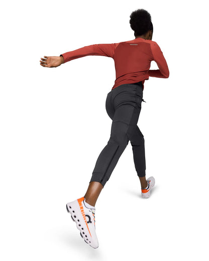 Woman wearing the On Weather Pants Colour Black - Back View Motion 