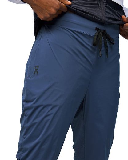 Woman wearing the On Weather Pants Colour Denim Navy - Front Detail Draw String 