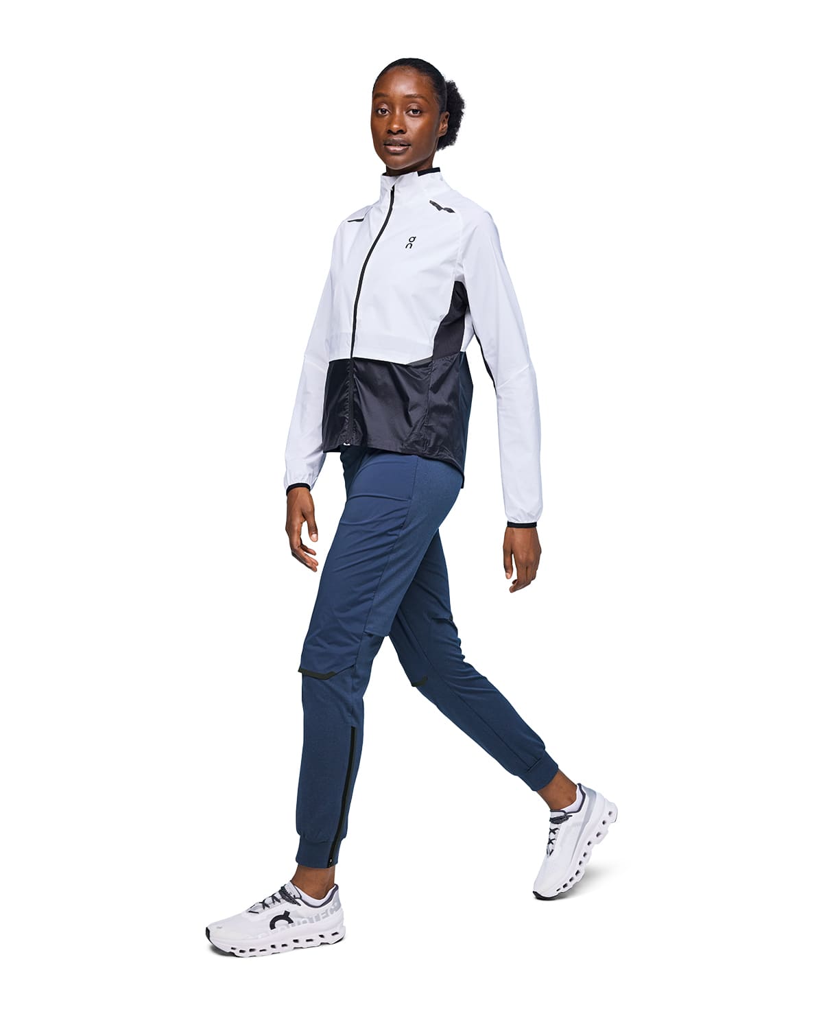 Woman wearing the On Weather Pants Colour Denim Navy - Front Side View 
