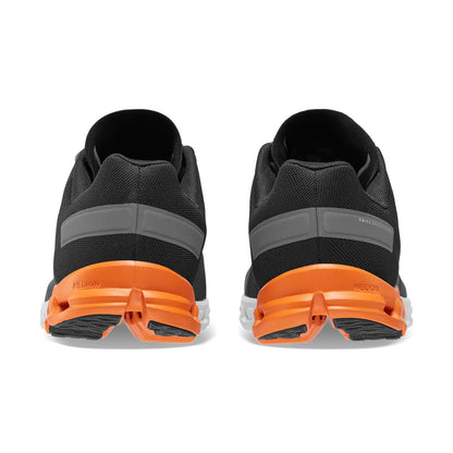Back view of the On Cloudflow Black-Tumeric men’s running shoe 