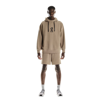 Full front view of male model wearing the On Club Hoodie in Desert 