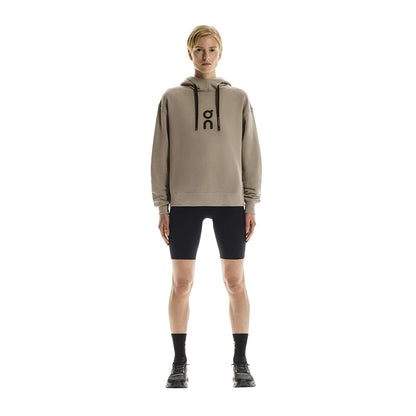 Full front view of female model wearing the On Club Hoodie in Desert 