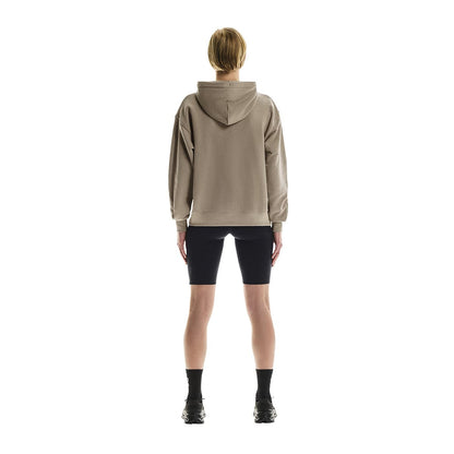 Full back view of female model wearing the On Club Hoodie in Desert 