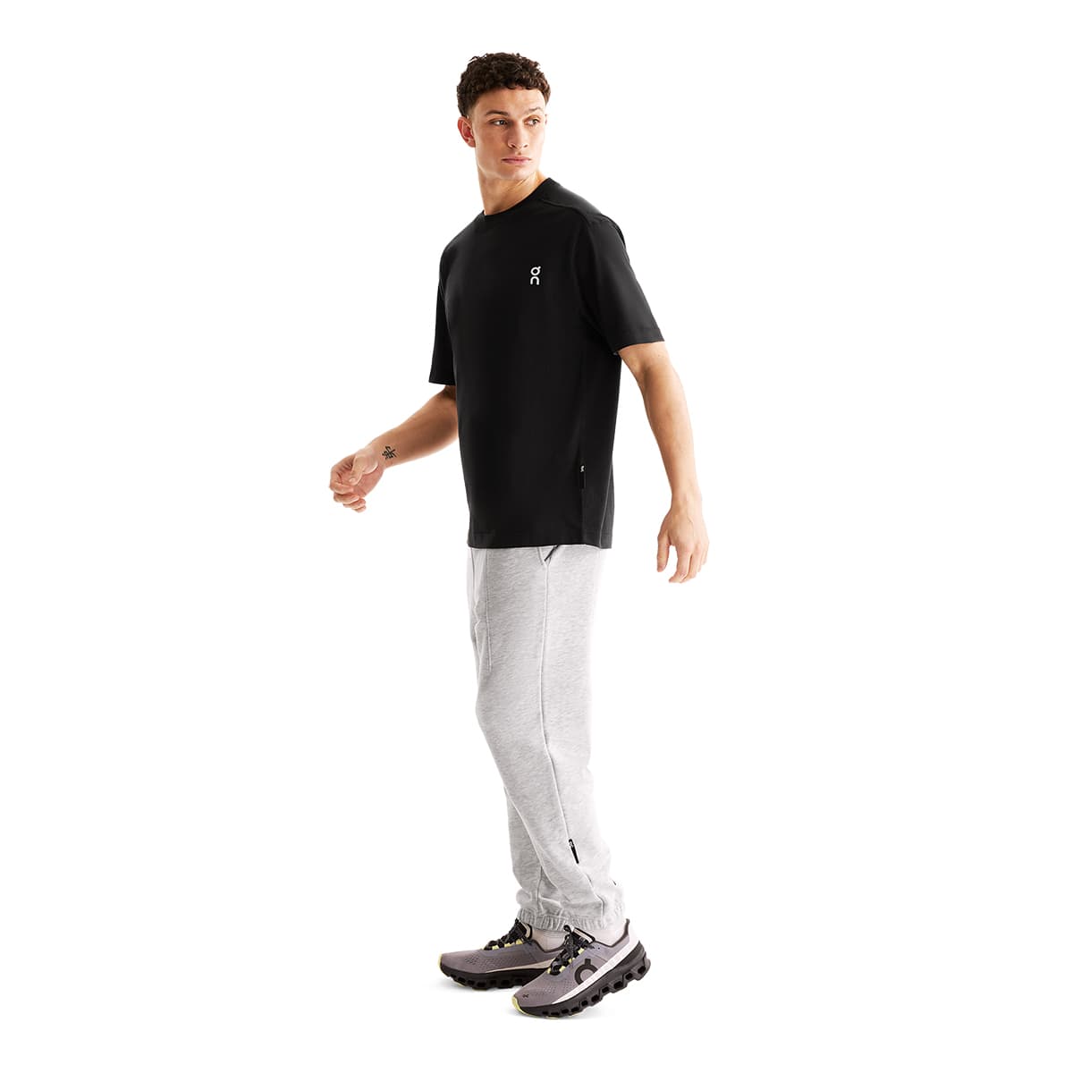 Man wearing the On Club T Colour Black - Side Profile #color_black