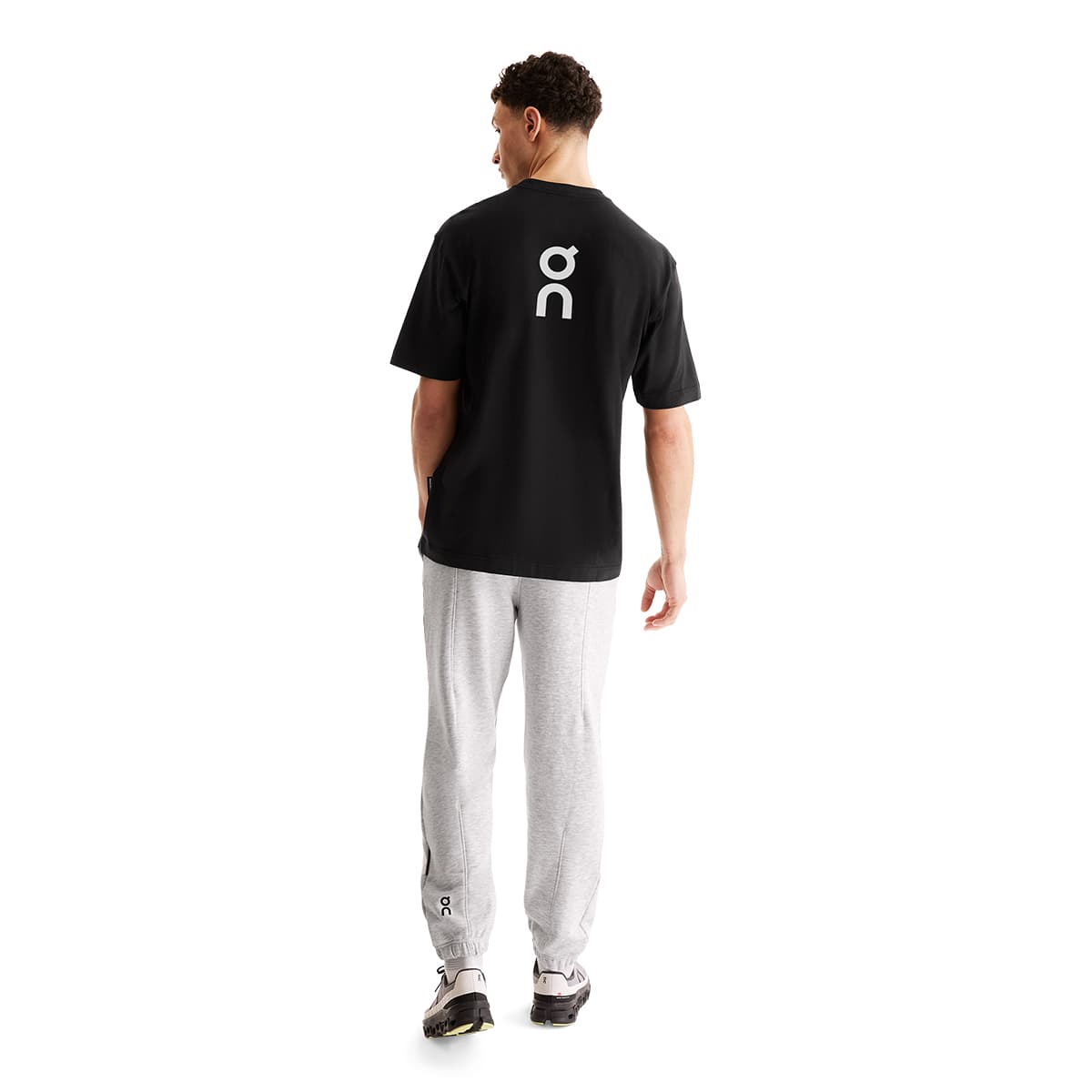 Man wearing the On Club T Colour Black- Back Logo Print #color_black