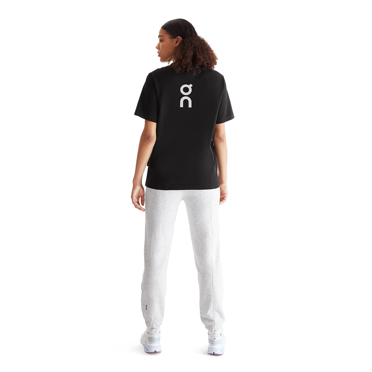 Women wearing the On Club T Colour Black - Back Logo Detail #color_black