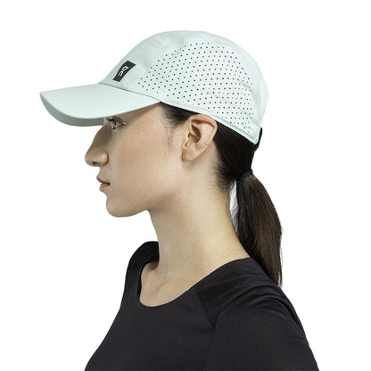 Female Model wearing the On Lightweight Cap Colour Creek 