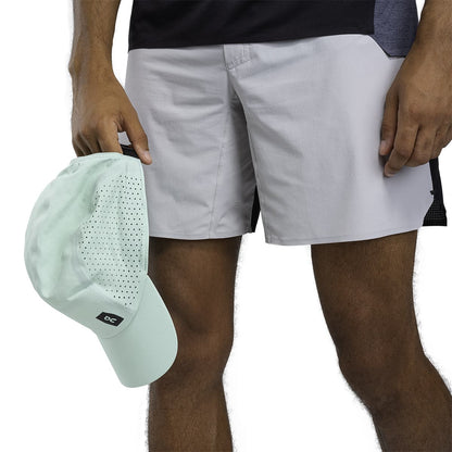 Male Model holding the On Lightweight Cap Colour Creek 