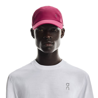 Front view of male model wearing the On Lightweight Cap in Grenadine 