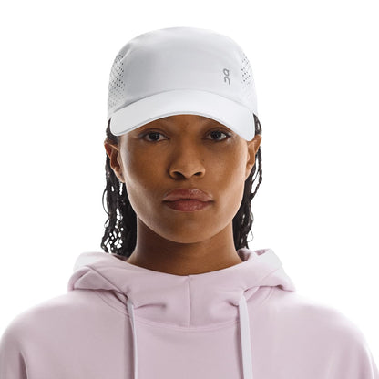 Front view of female model wearing the On Lightweight Cap in White 