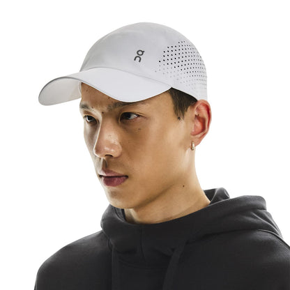 Front angled view of male model wearing the On Lightweight Cap in White 