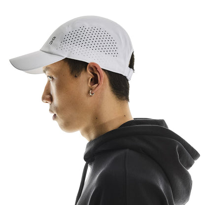 Side profile of male model wearing the On Lightweight Cap in White 