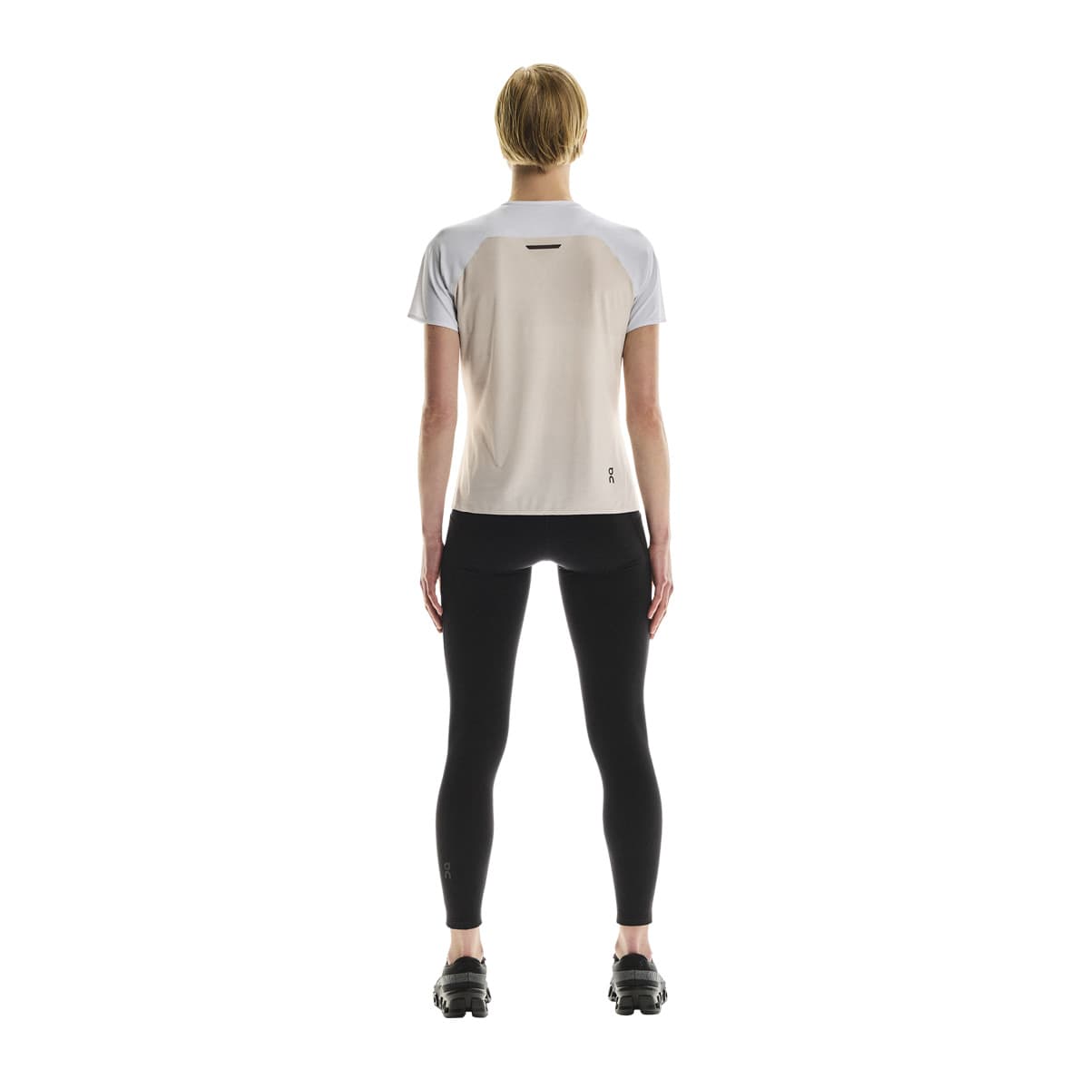 Full back view of female model wearing the On Performance T in White Silver 