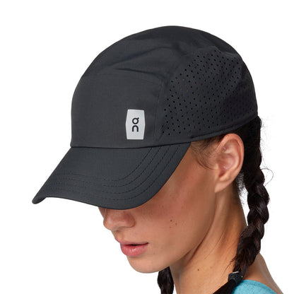 Female Model wearing the On Lightweight Cap Colour Black - Logo Detail 